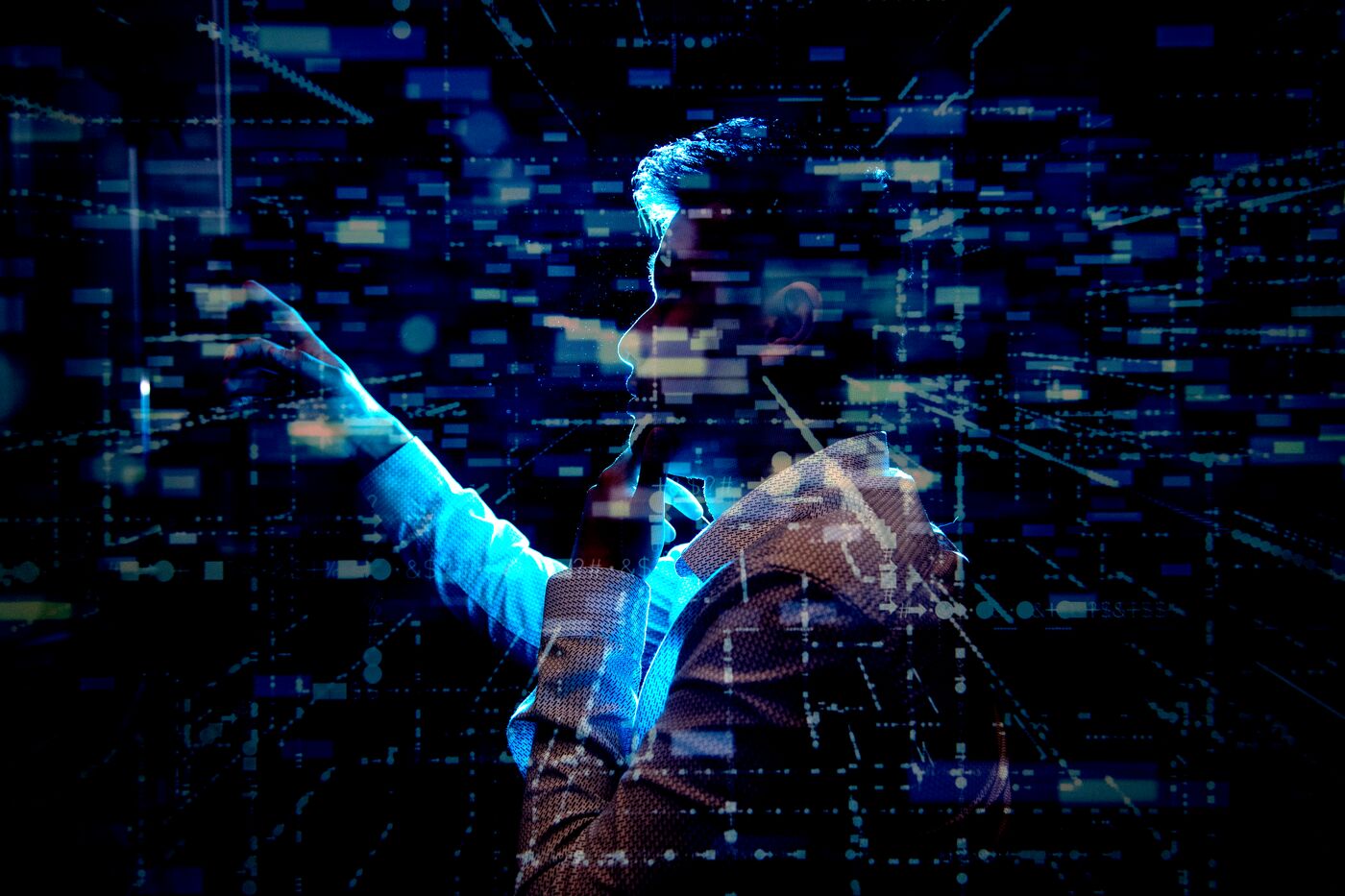 A woman looking at a screen with many technological graphics floating around her